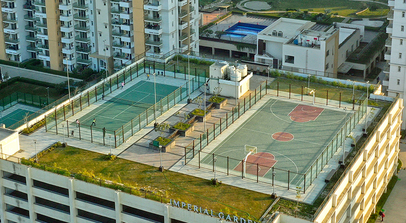 Outdoor tennis court and basketball court sports arena at Emaar Imperial Gardens Sector 102