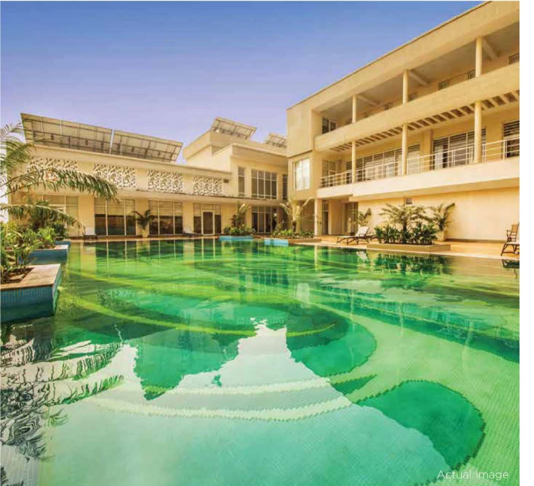 Resort-style swimming pool and poolside deck at Experion The Heartsong Sector 108